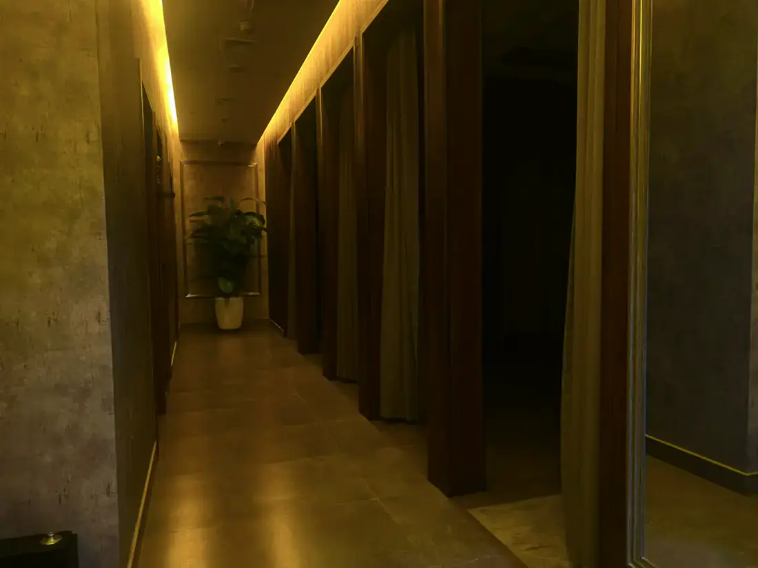 Treatment room detail at Next Balance Spa showing fresh towels and traditional Thai textiles